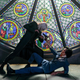 A white-haired man in a black trench coat points a sword at the prone but armed Spike Spiegel in front of a stained glass window in Netflix's live-action Cowboy Bebop..